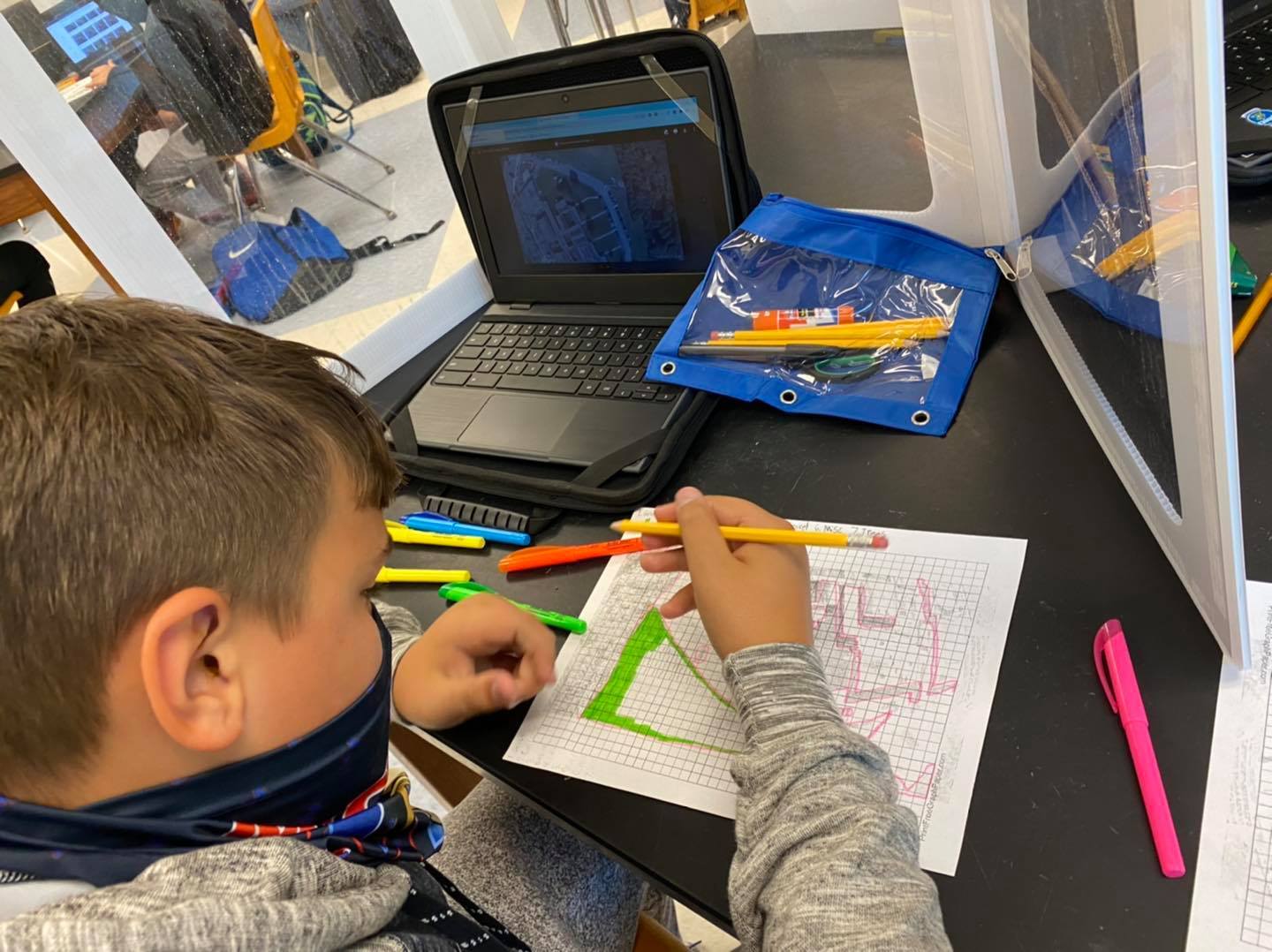 Student working on coloring a topographical map